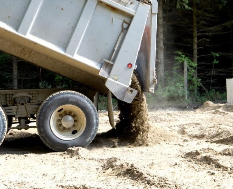 a truck dumping out building materials